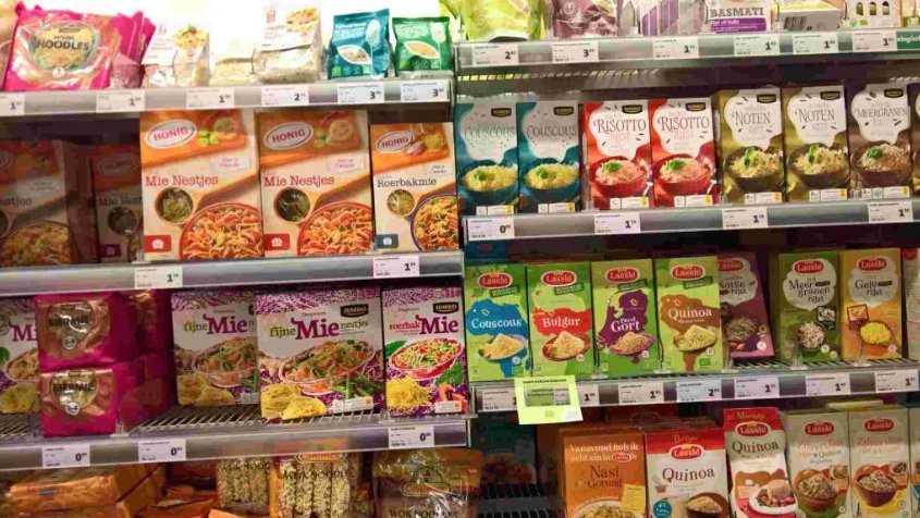 FMCG retail shelf packed with multiple SKUs across categories — illustrating the complexity FMCG salesmen face when serving outlets with varying stock and category mixes